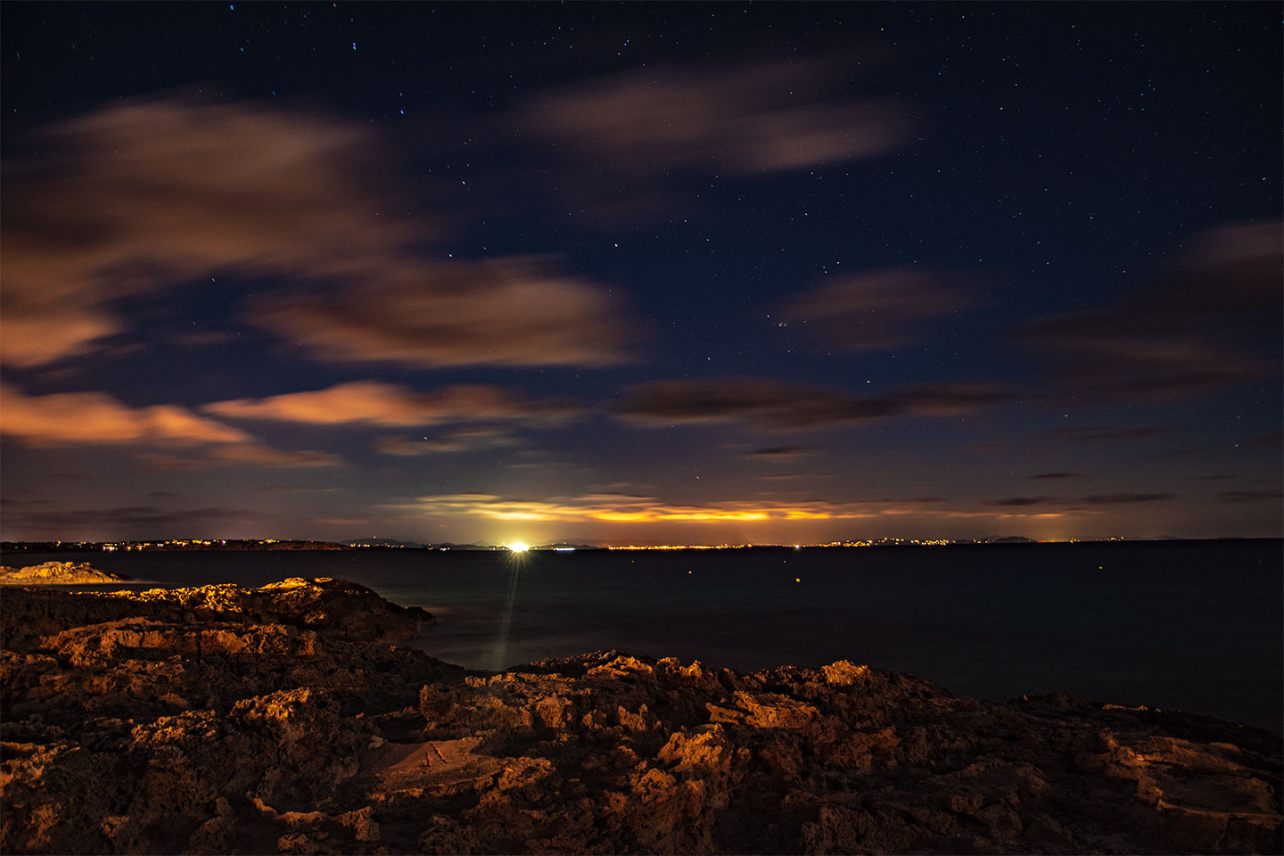 Slow speed shutter night photography, Ibiza view from Es Calo, Formentera, Spain, (Nos Dren).