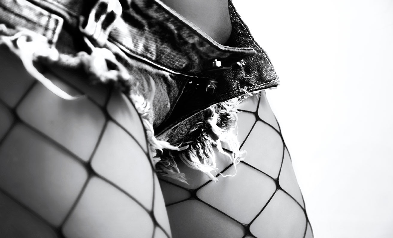 Black and white macroscopic photograph of fishnet and lingerie texture