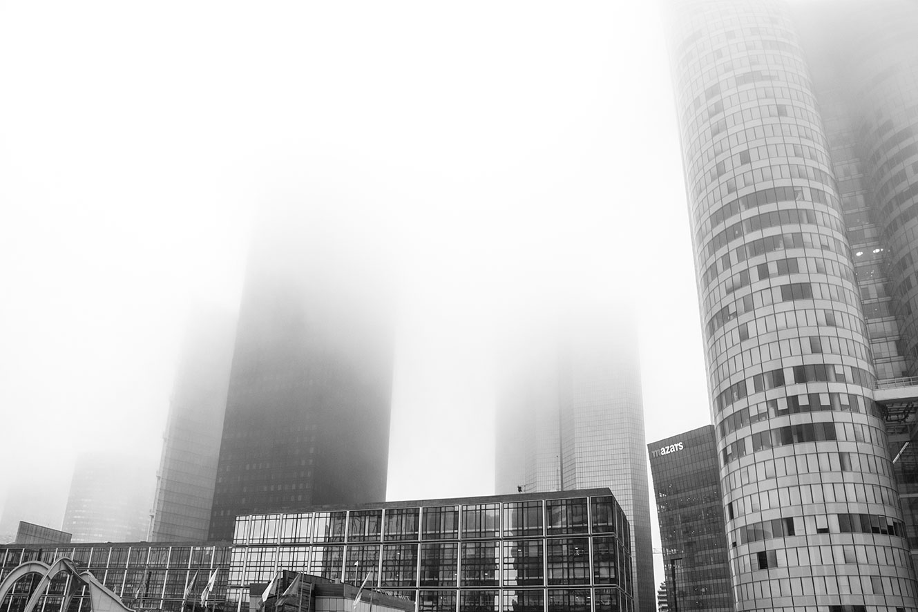 Mist and fog through the skyscrapers of Paris La Defense, France. (Nos Dren)