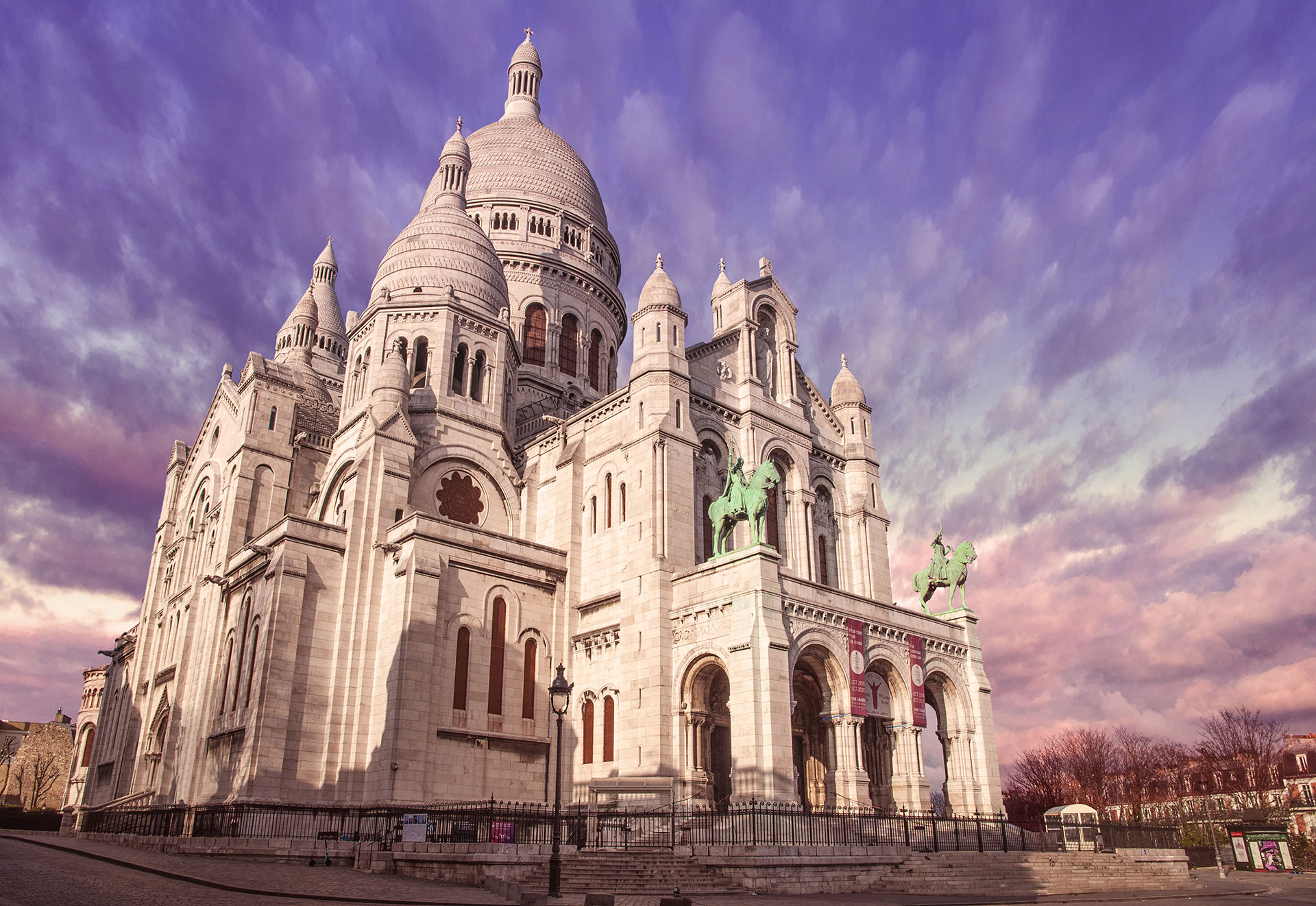 The Basilique du Sacre Coeur in Paris Montmartre without anybody around because of the quarantine due to the Coronavirus COVID-19 2020. Also with a nice purple sunset burning sky, (Nos Dren)