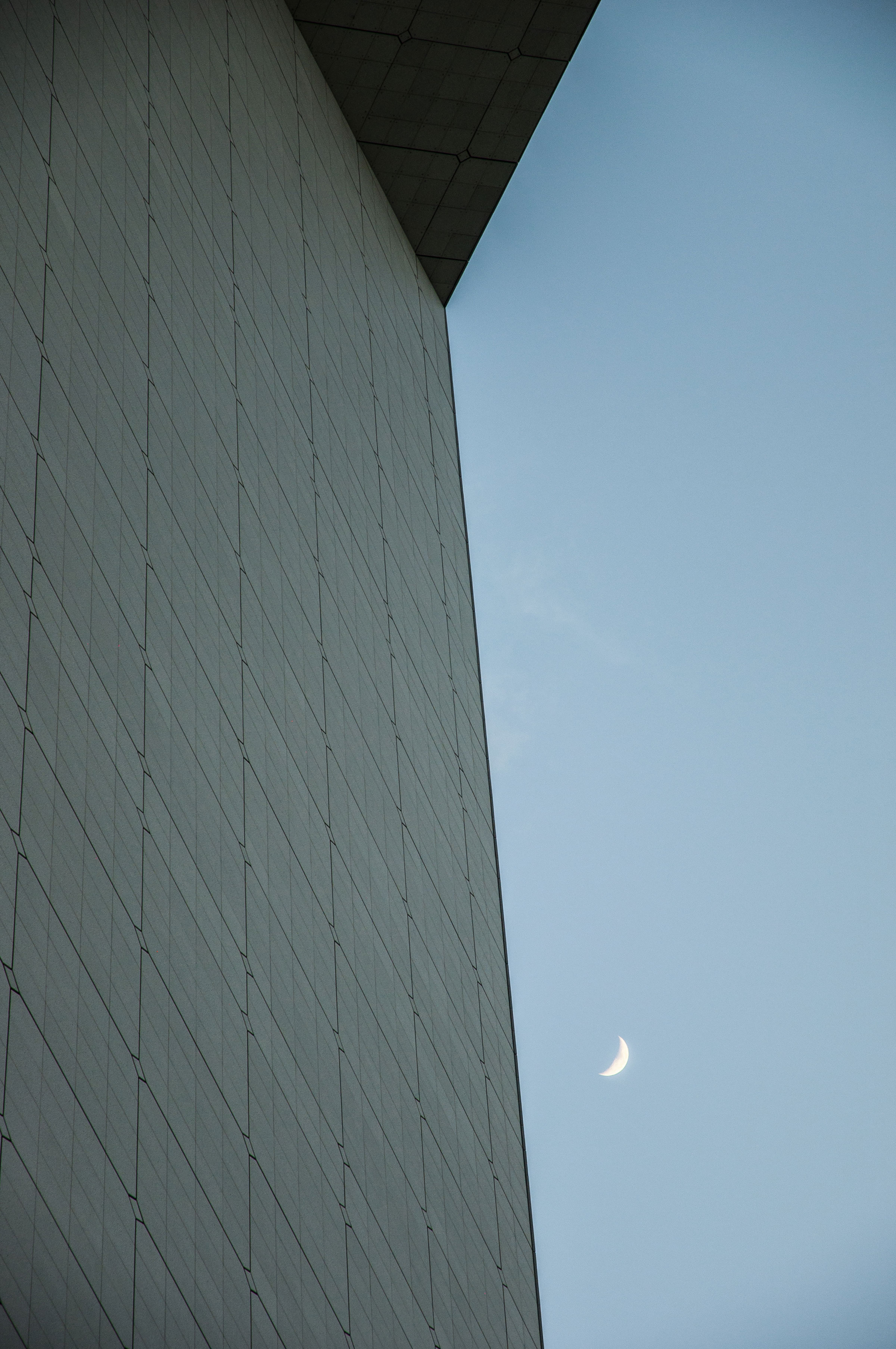 Abstract architecture photography with the moon and the top of the Arch of La Défense, Paris, France. (Nos Dren)
