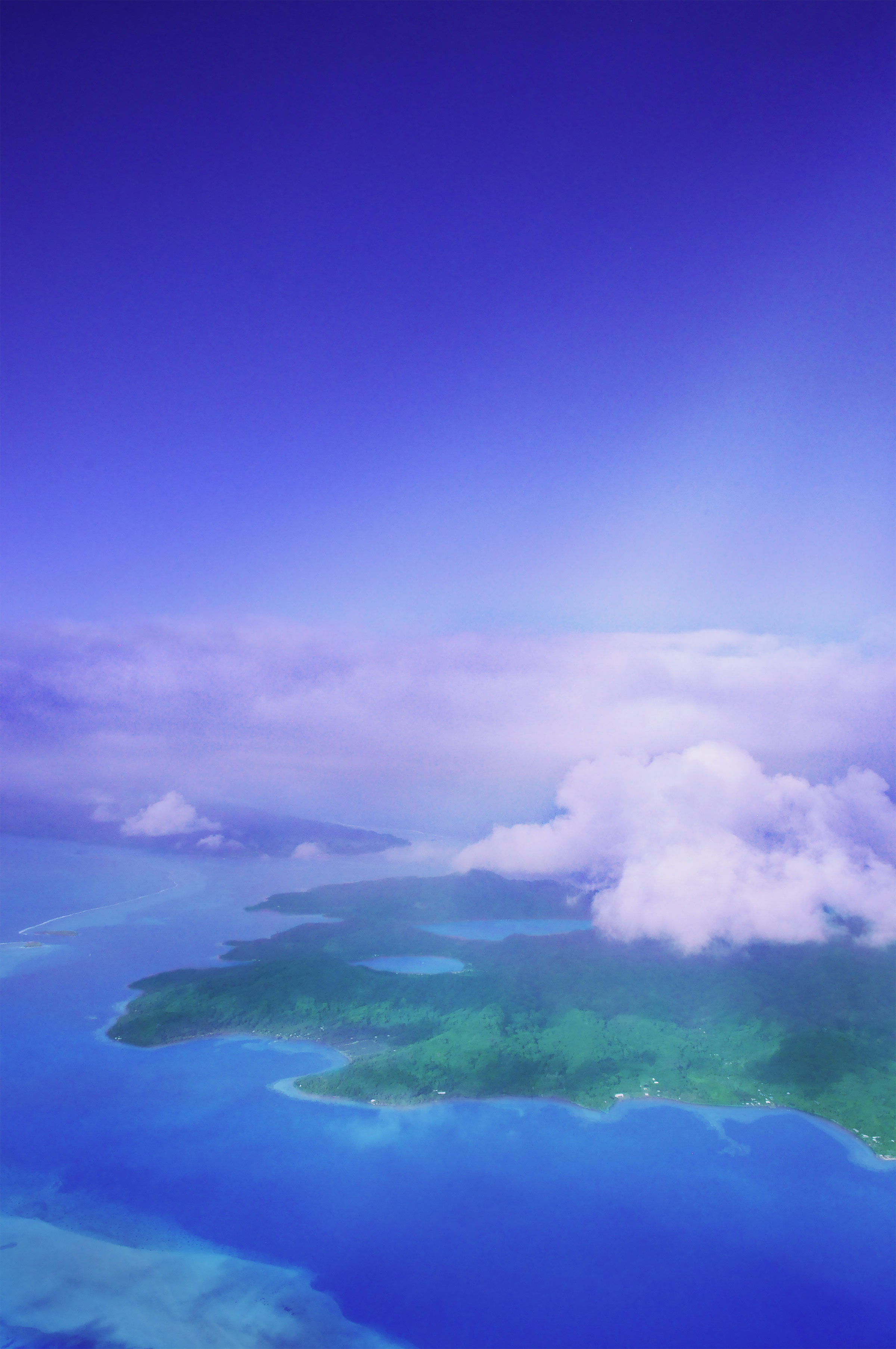French Polynesia, Raiatea island and its blue bays Faaha and Haamene view from the sky, and the island of Tahaa just behind. (Nos Dren)