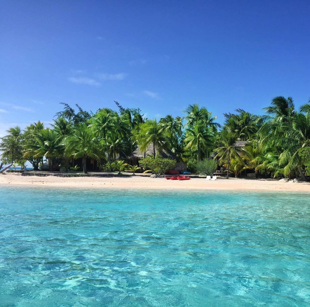 French Polynesia, Tikehau island, paradise beach with incredible transparent blue water, palm trees and white sand. (Nos Dren)