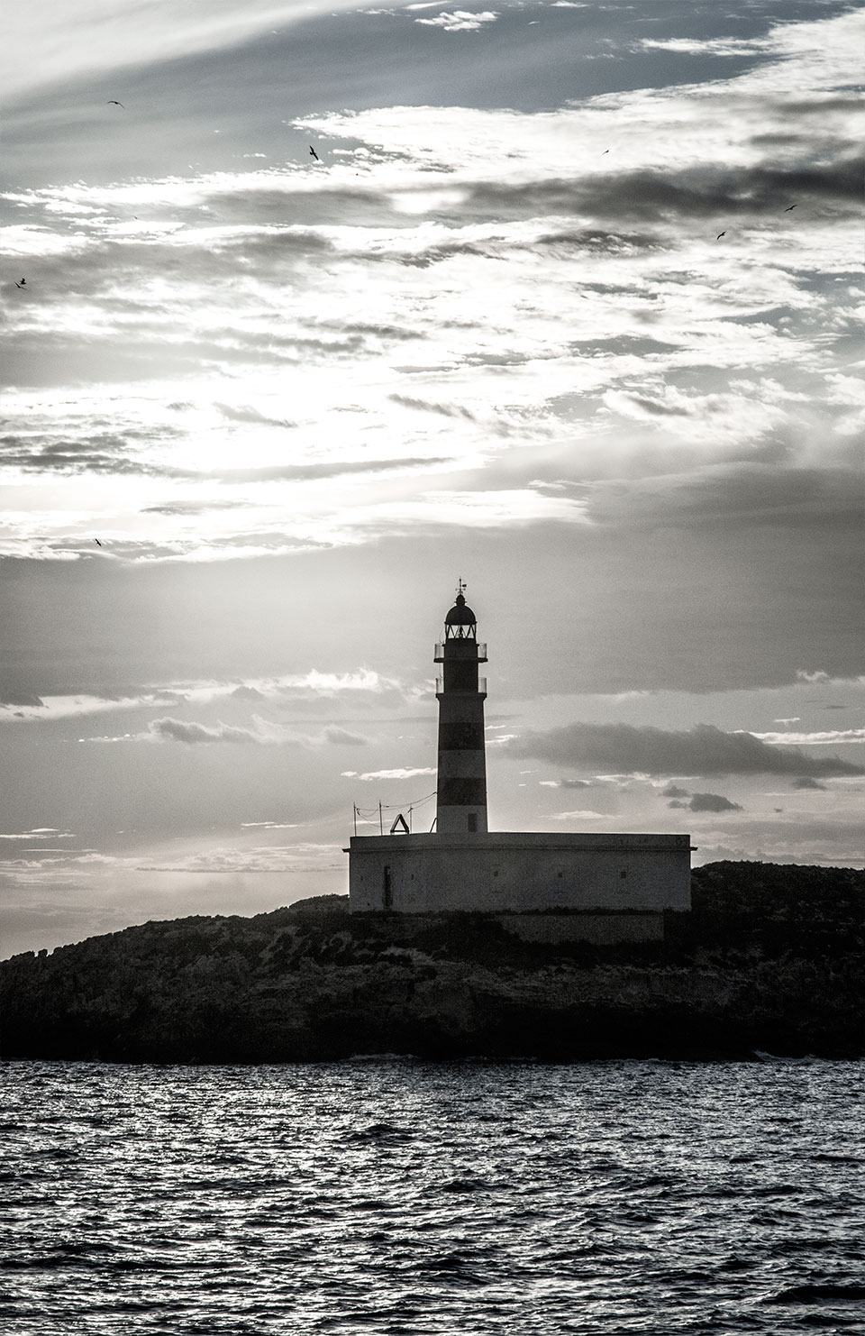 Black and white photography, Lighthouse Far de l'Illa des Penjats, Eivissa harbour and Dalt Vila, Balearic Islands, Catalonia, Spain. (Nos Dren).