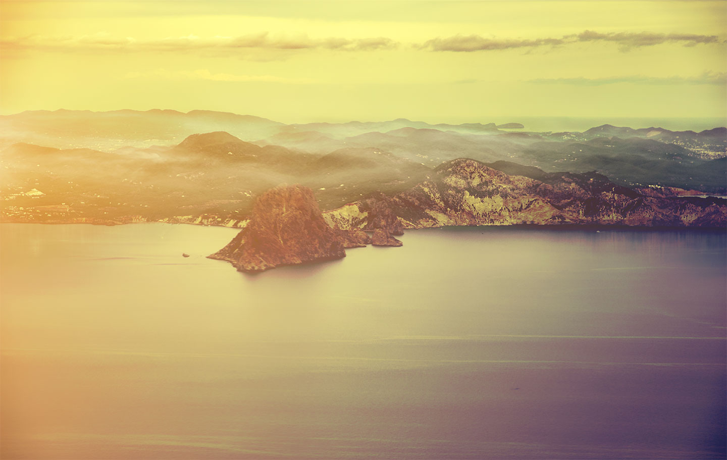 Ibiza island seen from the sky by sunset and mist fog on the hills, Catalonia, Spain. (Nos Dren).
