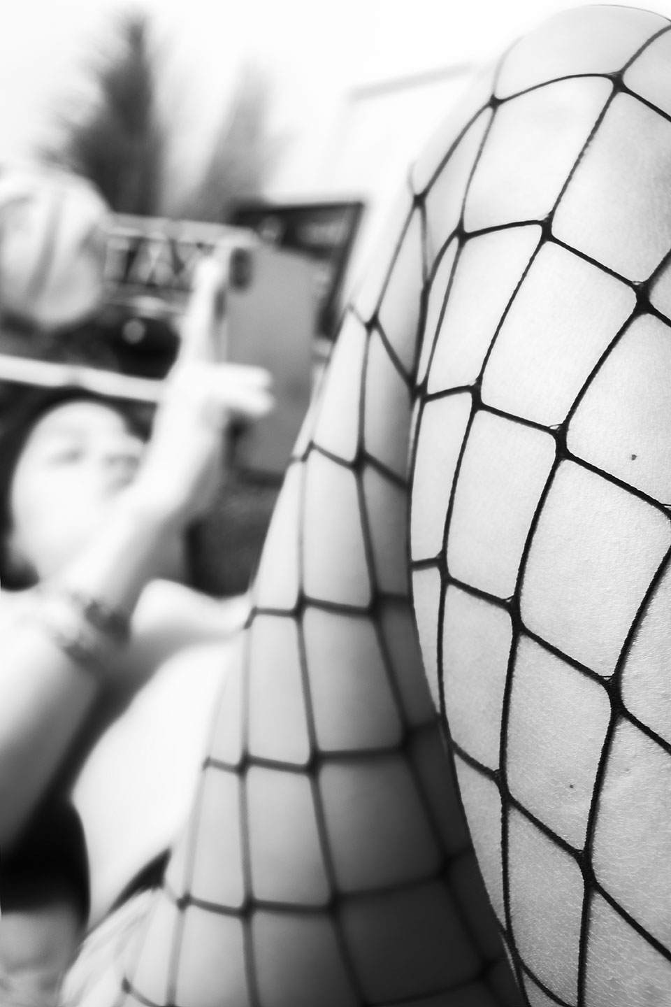 Black and white macroscopic photograph of fishnet and lingerie texture
