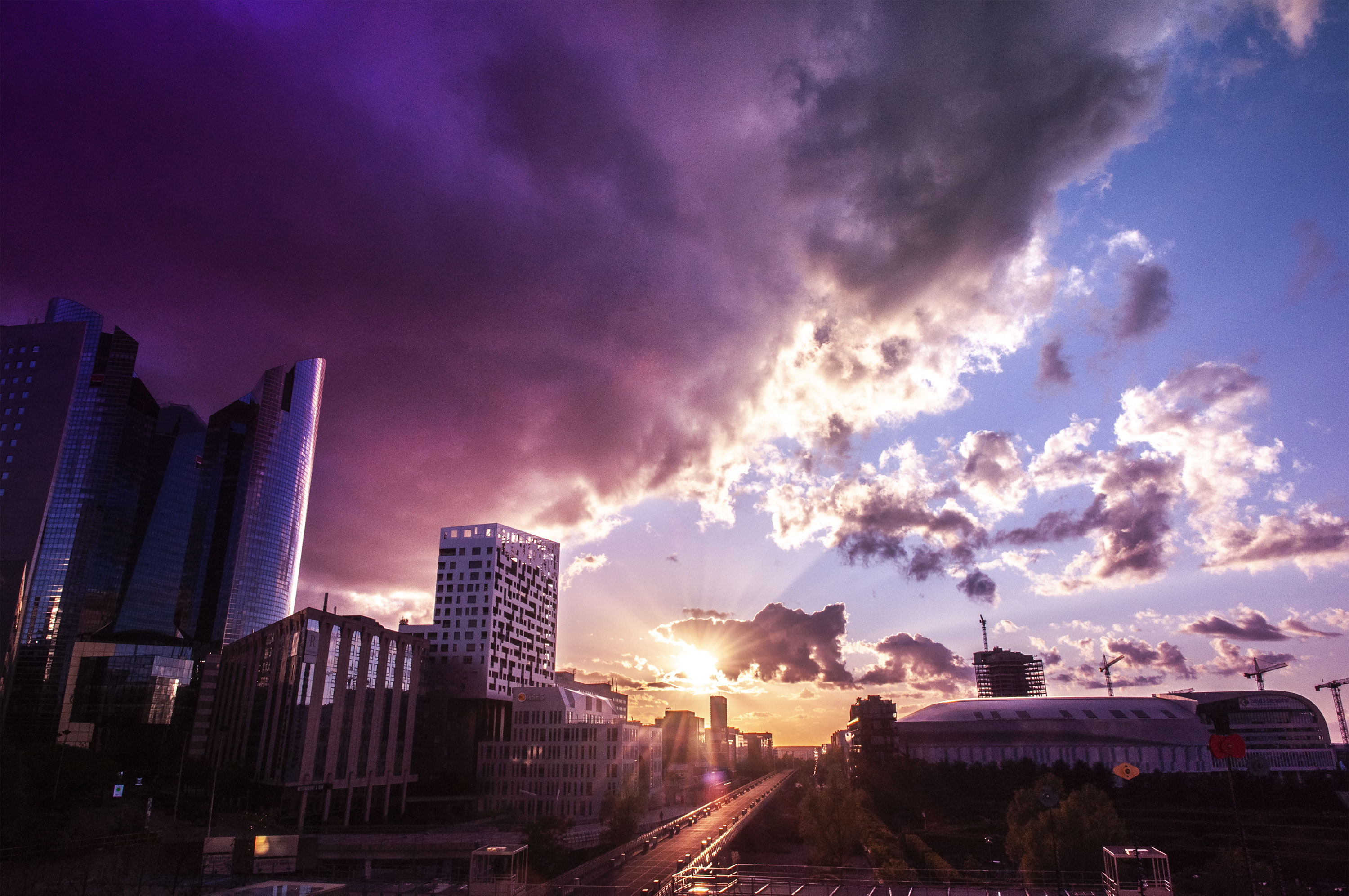 Nanterre La Defense under stormi sky and clouds by sunset ray light, (Nos Dren).